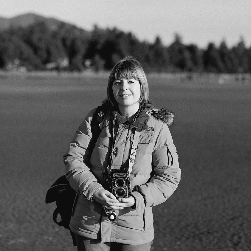 Black and white photo of a woman on a beach